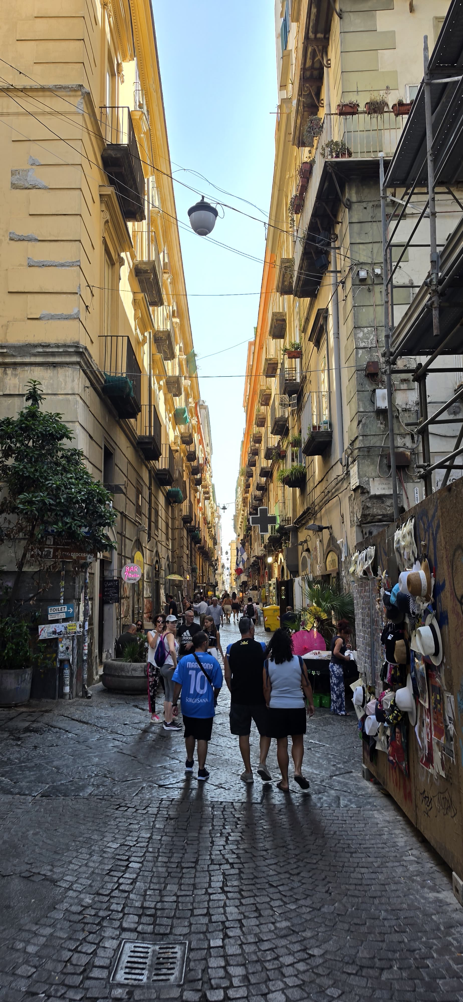 Family walking together through a Naples alley
